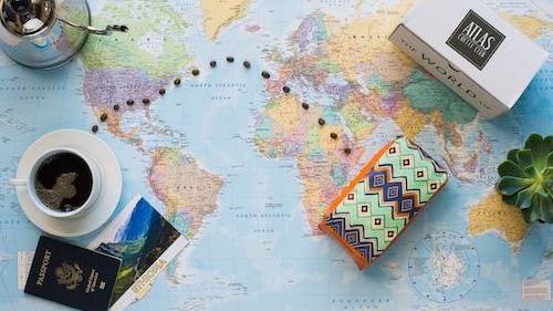 Bags of coffee sitting on a world map